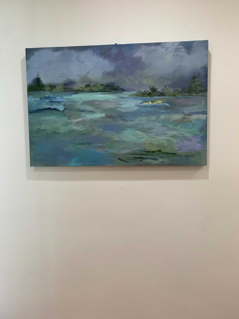 A painting of the ocean on display in a room.