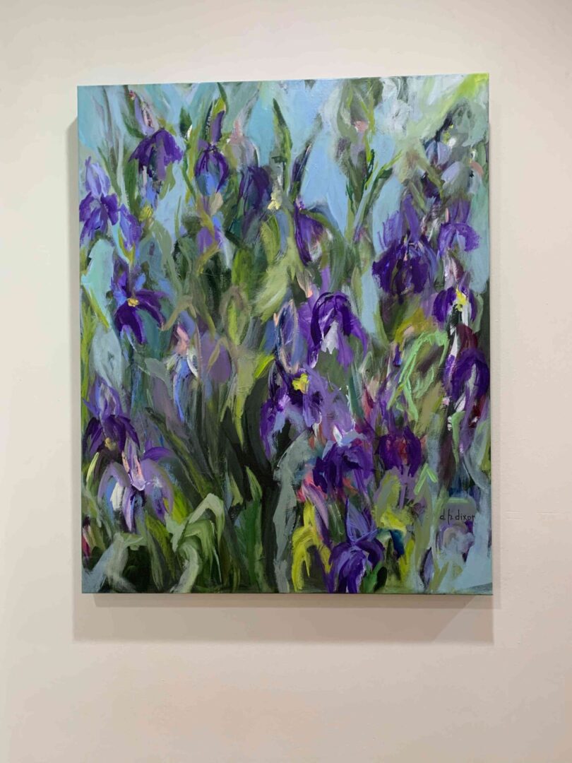 A painting of purple flowers on the wall